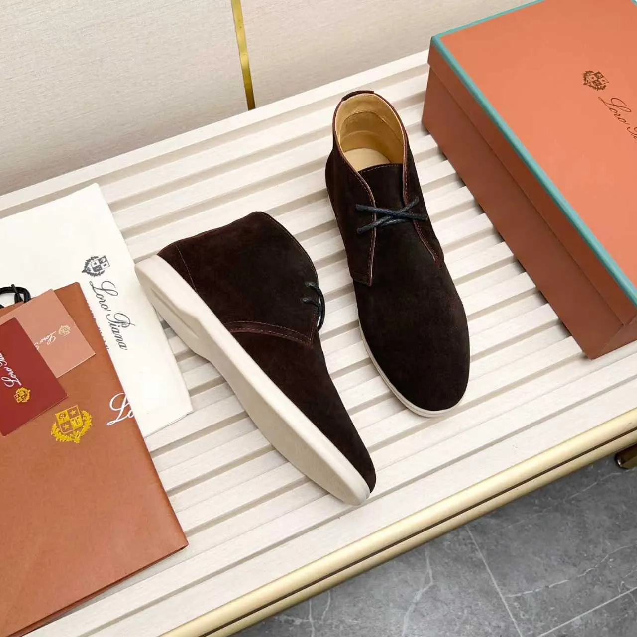 Men's Shoes 💰420 Loro Piana reimagines the desert boot—a modern, comfortable interpretation of a classic 1940s style. Crafted from suede calfskin, it exudes elegance. The tight texture of suede calfskin is not only durable but also looks casual and sophisticated. Add a timeless piece to your shoe collection, harmoniously blending comfort, style and Loro Piana's heritage of craftsmanship. Acetate satin detail on the inside White sole with LP lettering for added traction Space for a personalized signature on the heel Tonal suede trim Upper: 100% cow split suede Sole: 100% Rubber lining: Cow leather